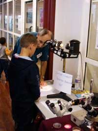David Rome demonstrating a
                  projecting microscope